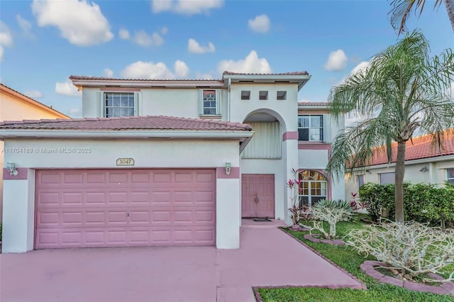 mediterranean / spanish-style house with a garage