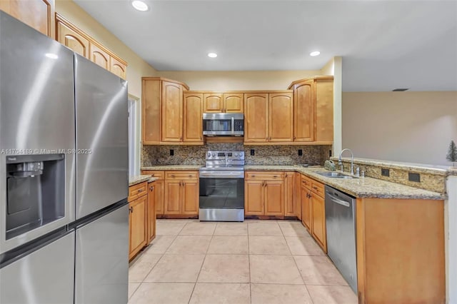 kitchen featuring sink, tasteful backsplash, light tile patterned flooring, light stone counters, and stainless steel appliances