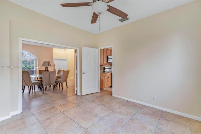 tiled empty room with ceiling fan