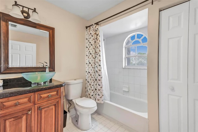 full bathroom featuring tile patterned floors, vanity, shower / bath combination with curtain, and toilet