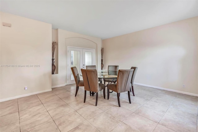 dining room featuring light tile patterned flooring and french doors