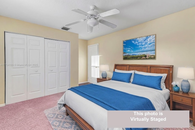 carpeted bedroom with ceiling fan and a closet