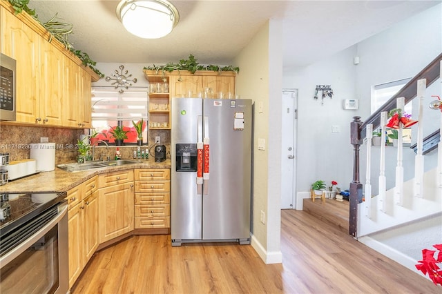 kitchen featuring sink, light hardwood / wood-style flooring, light brown cabinets, and appliances with stainless steel finishes