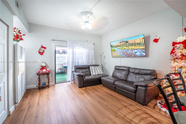 living room with hardwood / wood-style flooring and ceiling fan