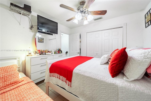 tiled bedroom featuring ceiling fan and a closet