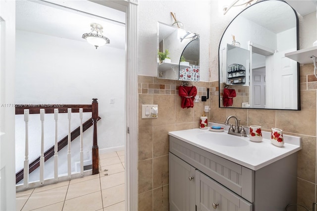 bathroom with vanity, tile patterned floors, and tile walls