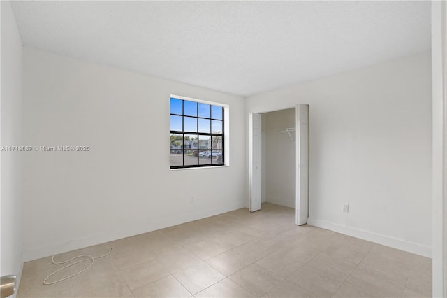 spare room with a textured ceiling