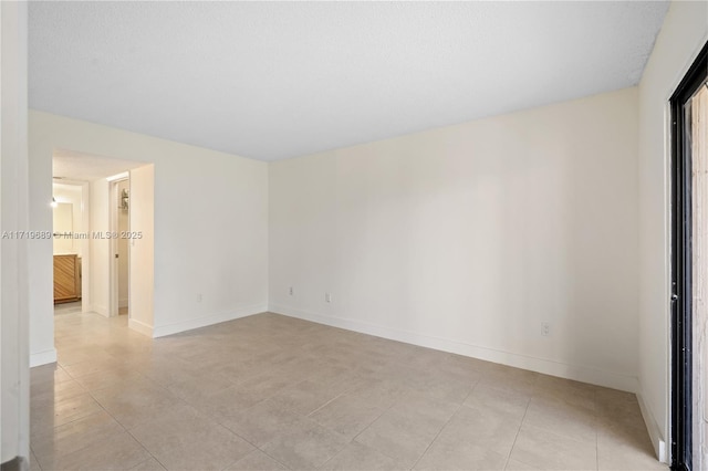 unfurnished room with light tile patterned floors