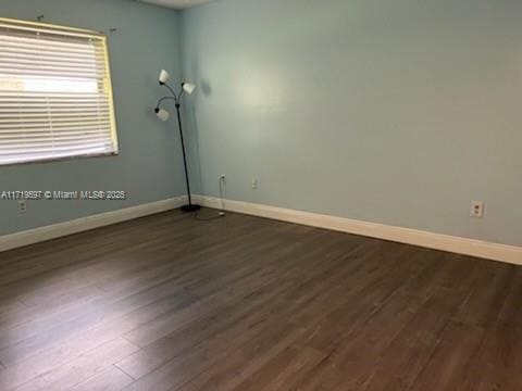 spare room featuring dark hardwood / wood-style floors