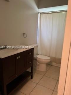 bathroom featuring tile patterned flooring, vanity, and toilet