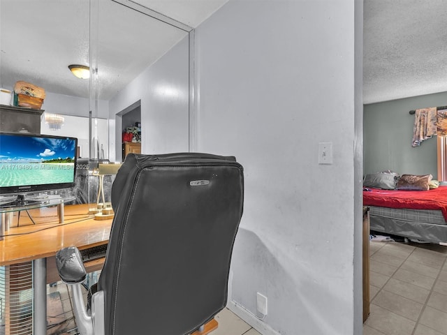 office space featuring light tile patterned floors and a textured ceiling