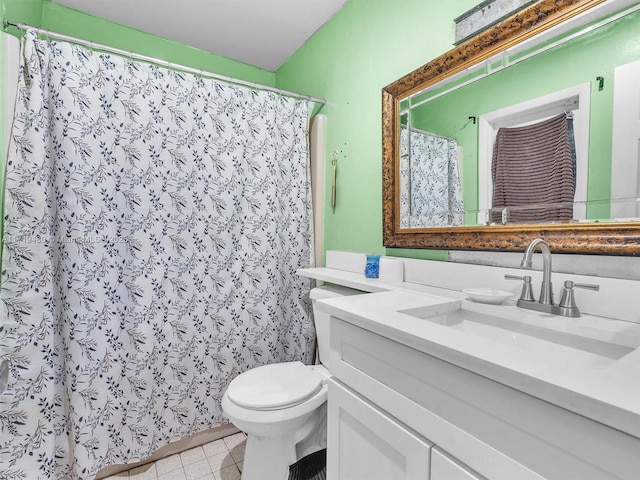 bathroom featuring tile patterned floors, vanity, and toilet