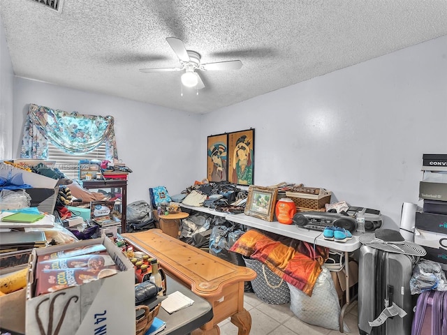 misc room featuring ceiling fan, light tile patterned flooring, and a textured ceiling