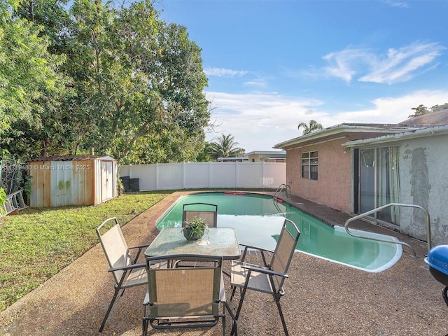 view of pool with a shed