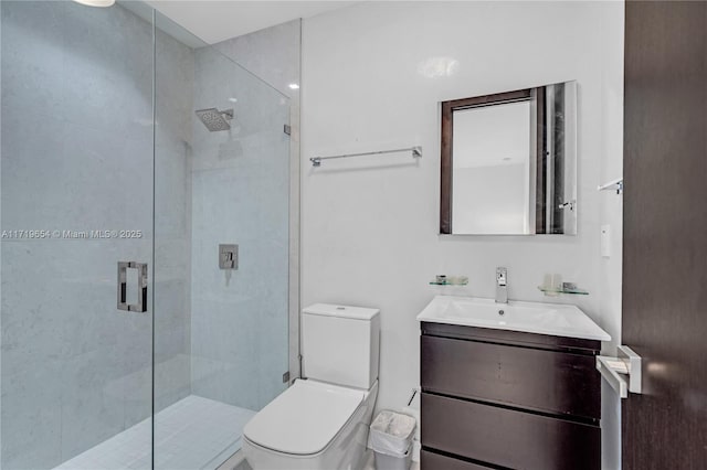 bathroom with vanity, toilet, and a shower with shower door