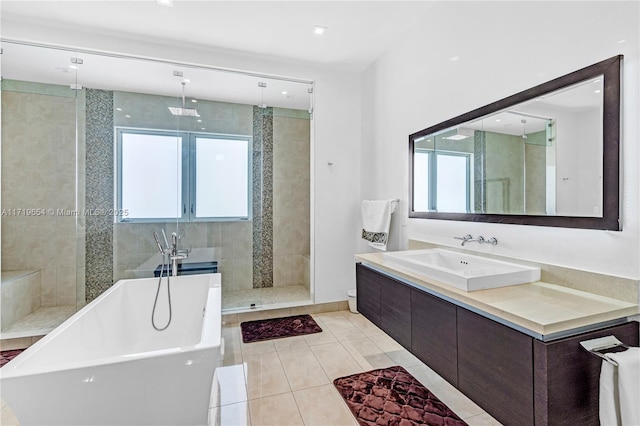 bathroom with tile patterned floors, vanity, and plus walk in shower