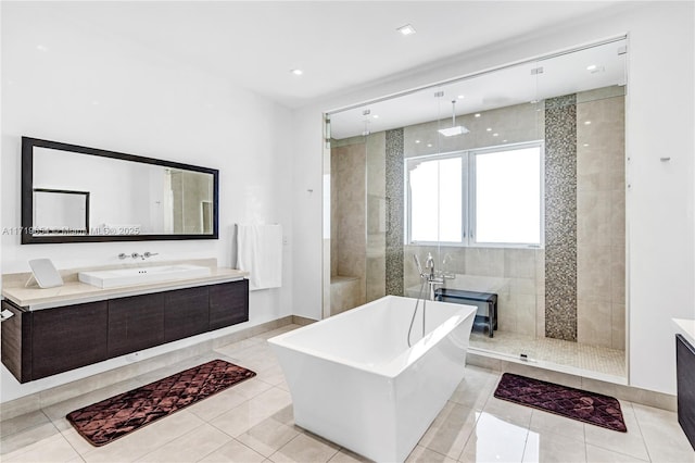 bathroom with tile patterned flooring, vanity, and shower with separate bathtub