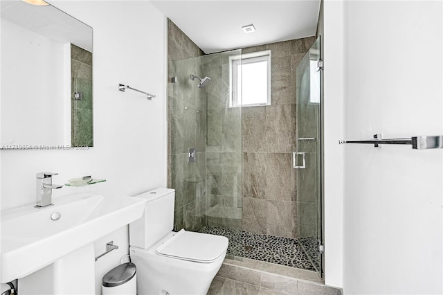 bathroom with walk in shower and toilet