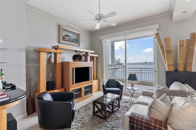 living room featuring ceiling fan and ornamental molding