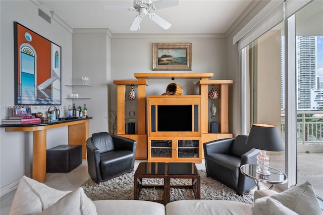 living room with plenty of natural light, ceiling fan, and crown molding