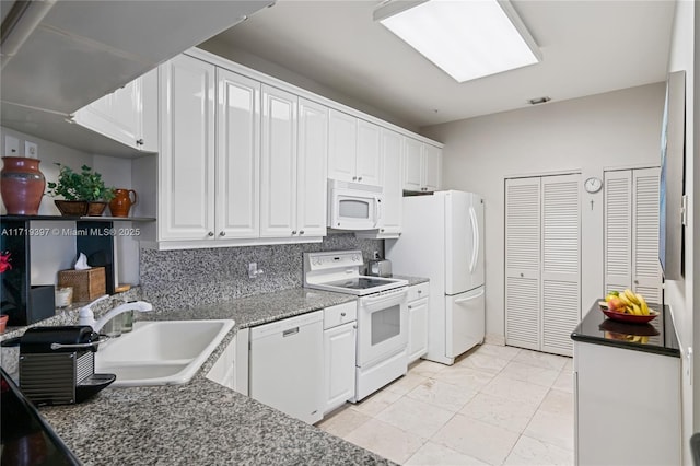 kitchen featuring white cabinetry, sink, and white appliances