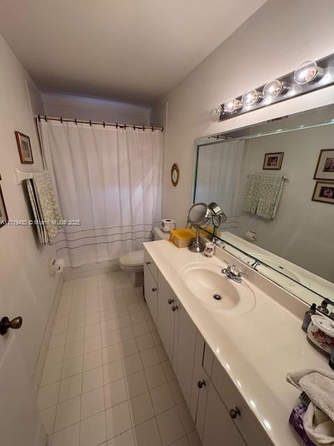 bathroom featuring tile patterned flooring, vanity, and toilet