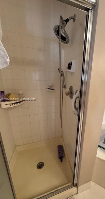 bathroom with tile patterned floors and walk in shower