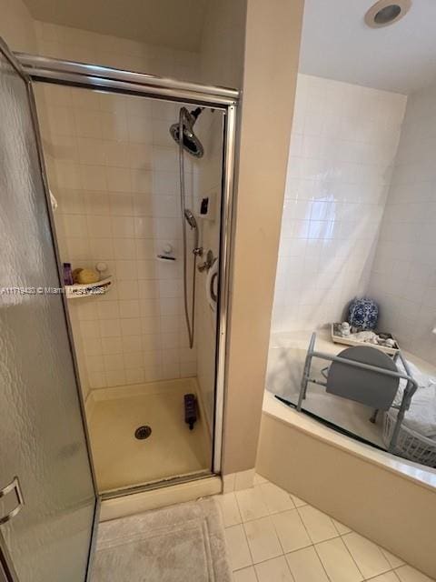 bathroom featuring a shower with door and tile patterned flooring