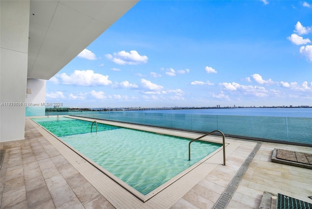 view of pool featuring a water view