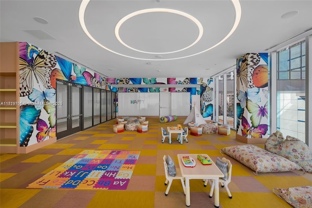 playroom featuring carpet flooring and floor to ceiling windows