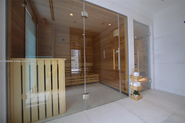 interior space featuring wood ceiling and wood walls