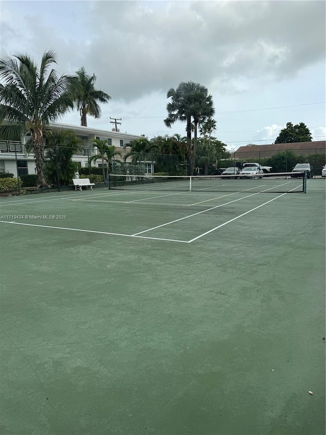 view of tennis court featuring fence