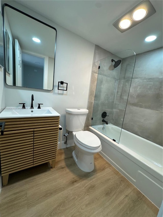 bathroom with bathtub / shower combination, vanity, toilet, and wood finished floors