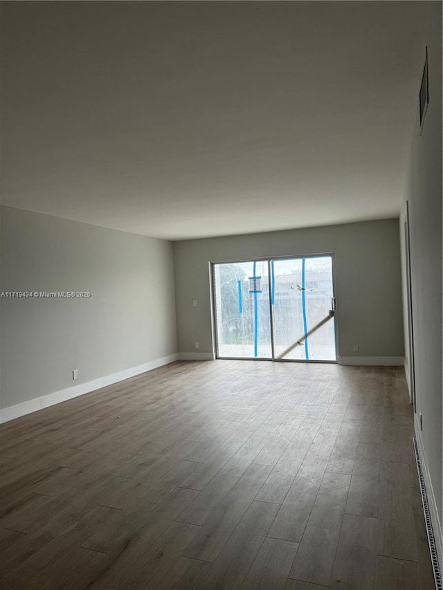 spare room featuring dark wood-type flooring