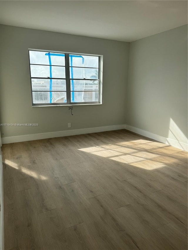 spare room featuring hardwood / wood-style flooring