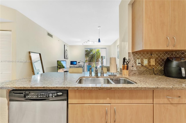 kitchen with dishwasher, light brown cabinets, sink, light stone countertops, and kitchen peninsula