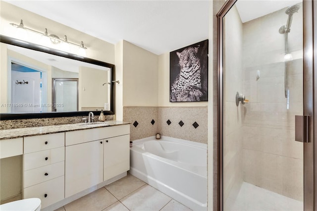 full bathroom with vanity, separate shower and tub, tile walls, tile patterned flooring, and toilet