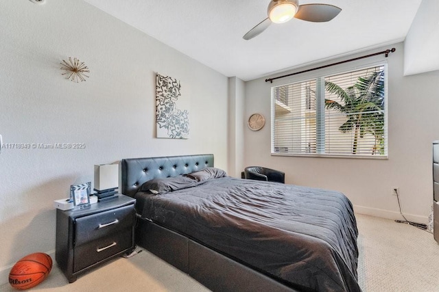 bedroom featuring light carpet, ceiling fan, and baseboards