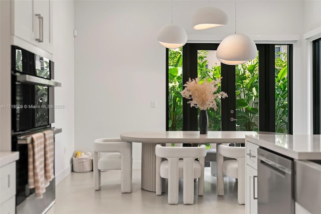 dining area with light tile patterned floors and a wealth of natural light