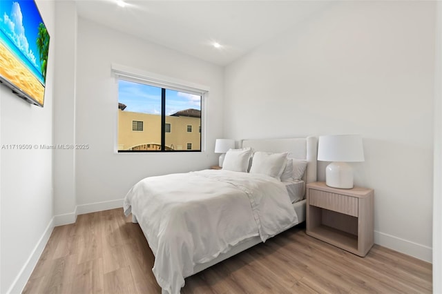 bedroom with light hardwood / wood-style floors