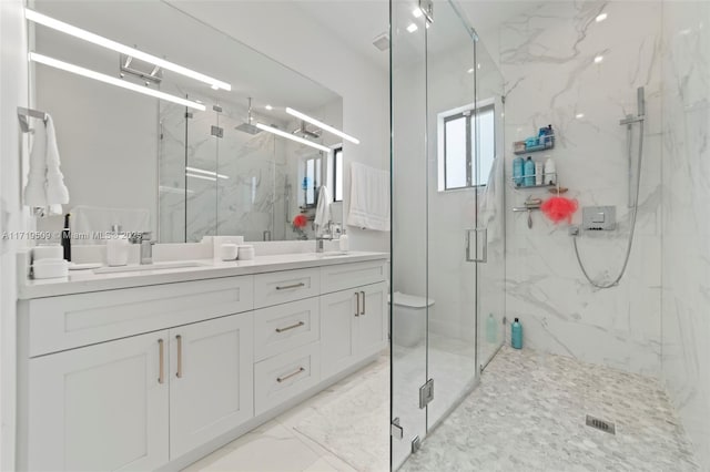 bathroom featuring vanity, an enclosed shower, and toilet