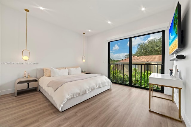 bedroom featuring access to outside and wood-type flooring