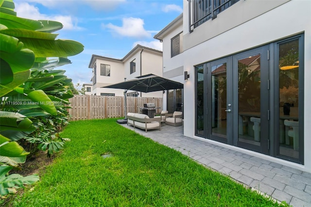 view of yard featuring french doors and a patio area