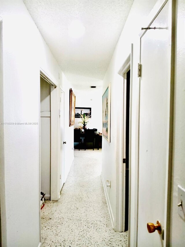 hallway featuring a textured ceiling