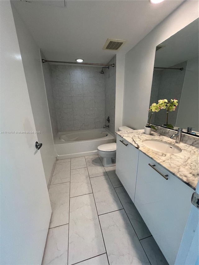 full bathroom featuring vanity, toilet, and tiled shower / bath