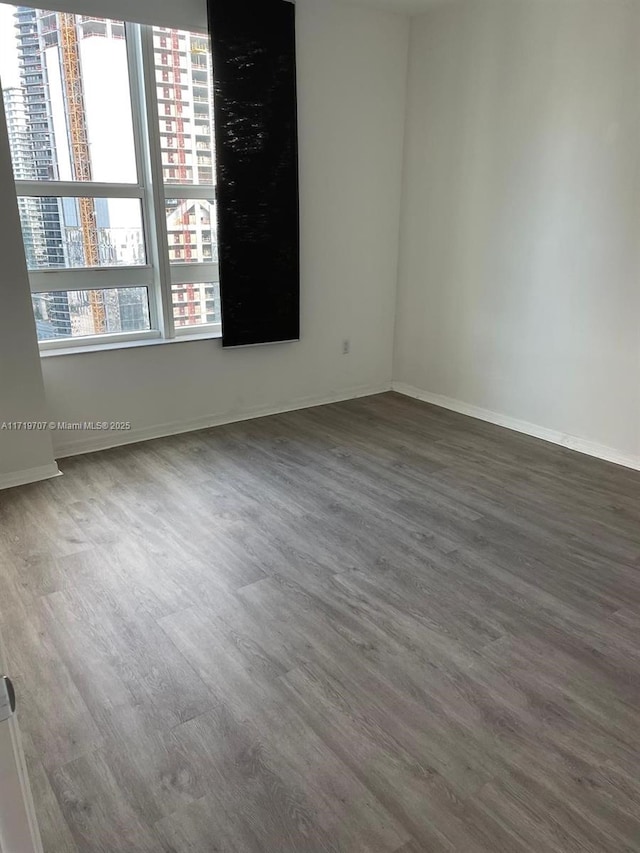 unfurnished room featuring dark hardwood / wood-style floors