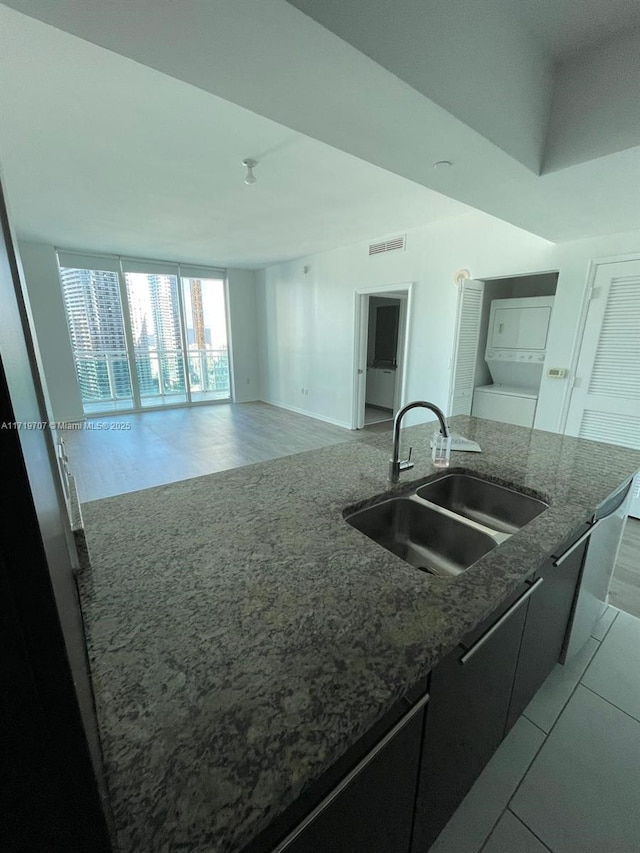 kitchen featuring a kitchen island with sink and sink