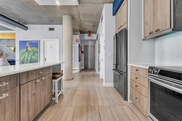 kitchen with stainless steel appliances and tasteful backsplash