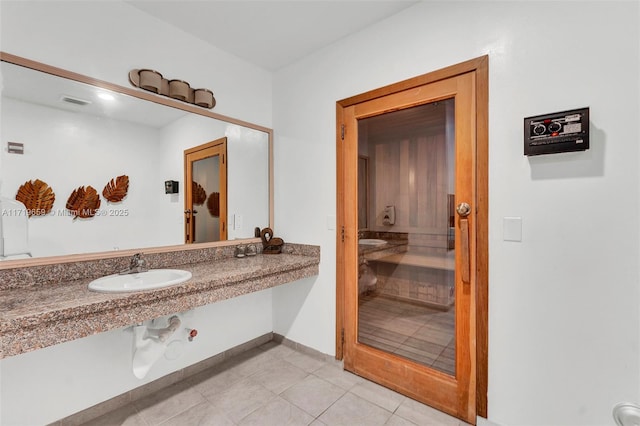 bathroom featuring sink and tile patterned flooring