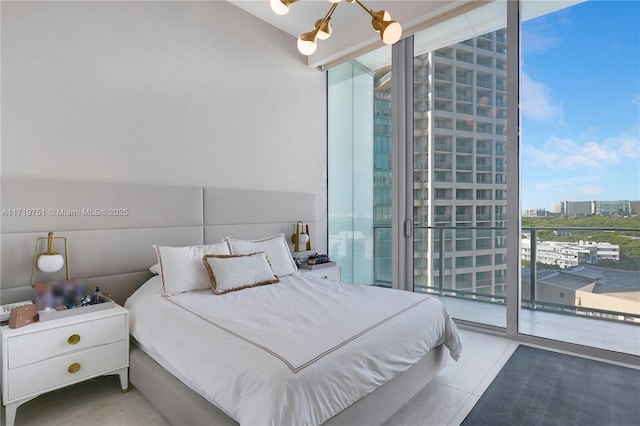 tiled bedroom featuring access to outside, floor to ceiling windows, and a chandelier